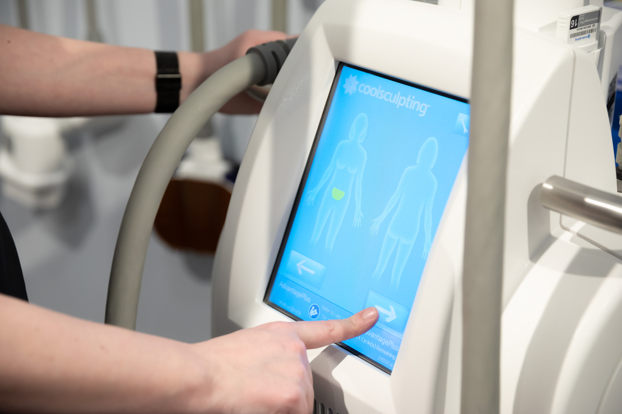 A provider uses a touchscreen to prepare the technology for CoolSculpting near Eden Prairie, MN