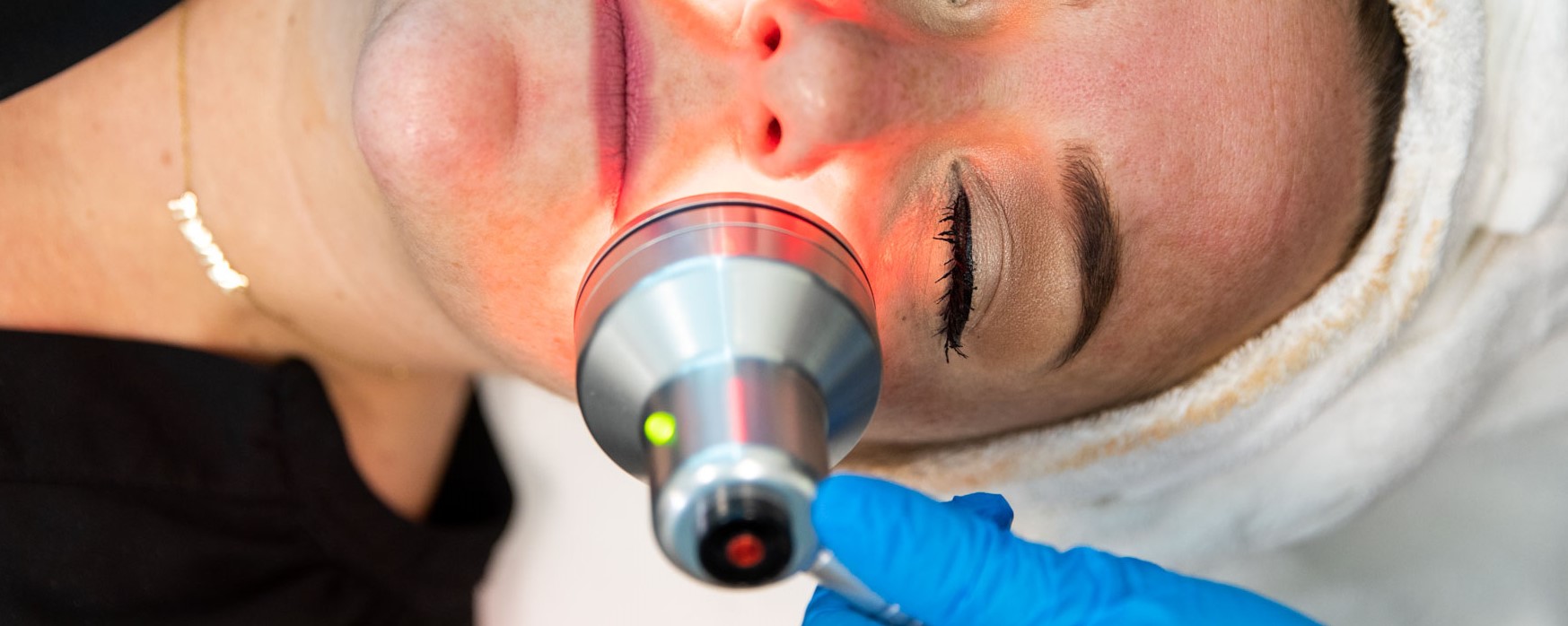 woman lying on back having hydrafacial experience with medical facials near me in Plymouth, MN