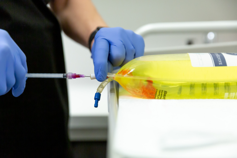 vively body science provider adding nutrients to an iv bag as part of iv infusion in minneapolis