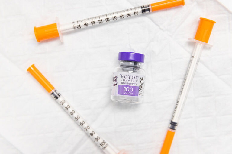 Syrngies laid on next to a bottle of Botox for TMJ near Minneapolis